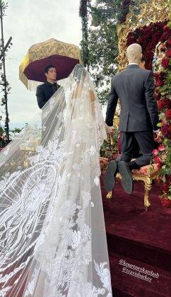 Kourt walked to the altar with a custom white silk and satin lace gown, and a corset signed by Dolce & Gabbana, and in honor of her husband, the same image of the Virgin Mary that he has tattooed on his head was embroidered on the veil. (Photo: Instagram release)