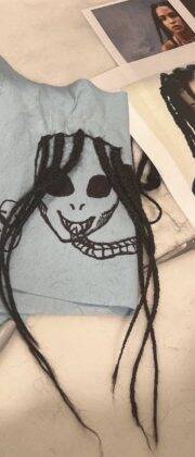 She used a black pen to draw two dark mysterious faces with dark eyes. And braids were glued together that looked like they were made from real hair. (Photo: Instagram release)